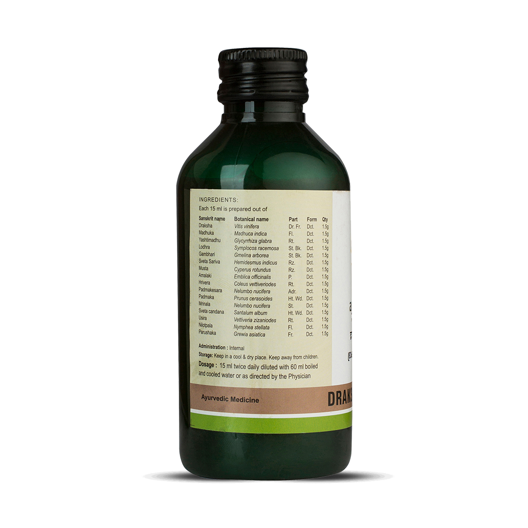 Side view of the dark green glass bottle of Kerala Ayurveda Drakshadi Kwath, showing a detailed list of ingredients prepared per 15 ml, including botanical names like Vitis vinifera and Madhuca indica. Administration, dosage (15 ml twice daily diluted with 60 ml water), and storage instructions are also visible. – Kerala Ayurveda India