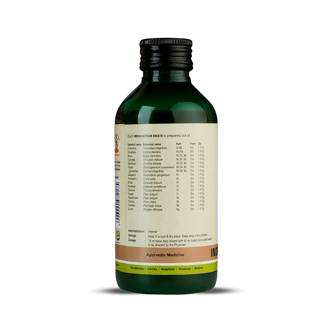 Side view of the dark green glass bottle of Kerala Ayurveda Indukantham Kwath, showing a detailed list of ingredients prepared per 15 ml, including Sanskrit name, botanical name, part, form, and quantity. Administration, dosage (15 ml twice daily diluted with 60 ml water), and storage instructions are also visible. – Kerala Ayurveda India