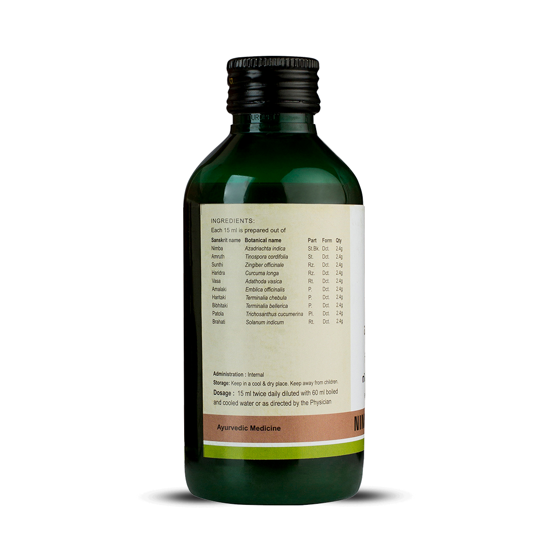 Side view of the dark green glass bottle of Kerala Ayurveda Nimbadi Kwath, showing a detailed list of ingredients prepared per 15 ml, and administration, dosage (15 ml twice daily diluted with 60 ml water), and storage instructions. – Kerala Ayurveda India