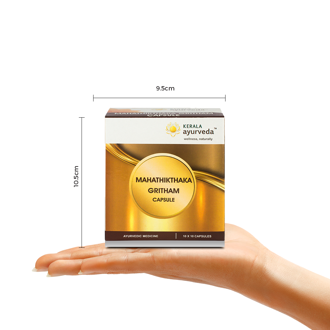 Hand displaying a gold-white Kerala Ayurveda Mahathikthaka Gritham capsule carton with arrows showing its size (10.5 cm × 9.5 cm) – Kerala Ayurveda India