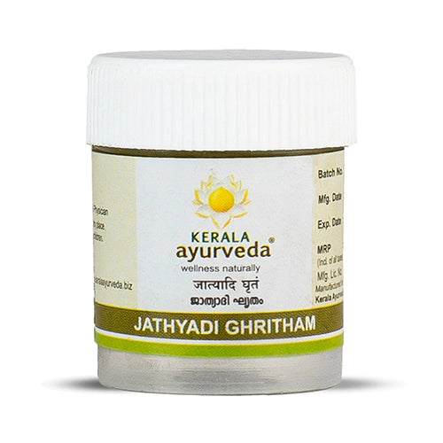 Front view of a small, clear plastic jar with a white lid, filled with light brown Kerala Ayurveda Jathyadi Ghritham. The label displays the product name in English and Malayalam script, along with the Kerala Ayurveda logo. – Kerala Ayurveda India

