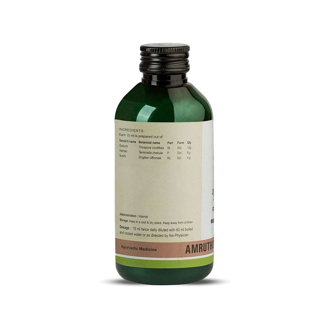 Side view of the same Amruthotharam Kwath bottle highlighting the ingredients panel (Guduchi, Haritaki, Sunthi), dosage of 15 ml twice daily, and storage advice – Kerala Ayurveda India

